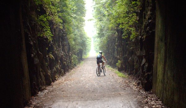 Biker riding through tunnel at Tunnel Hill bike trail